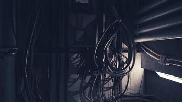 CGI Tangled wires and cables in a dimly lit industrial environment video