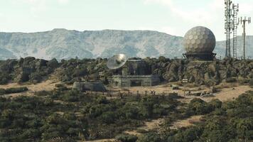 CGI Distant view of satellite dishes and a spherical radar on rocky terrain video
