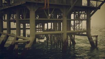 CGI Oil rig structure with support pylons reflecting on calm waters video