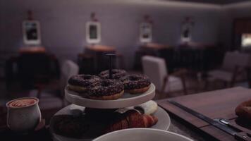 CGI Dessert selection with pastries on display in a cozy cafe at night video