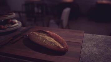CGI Rustic bread rests on a wooden cutting board in a cozy kitchen setting video