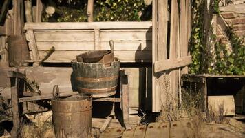 CGI Old wooden shed with rustic buckets and weathered fencing in sunlight video