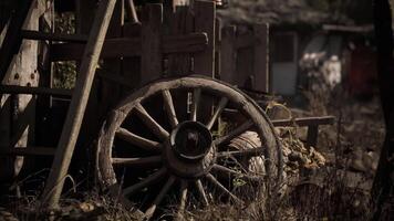 CGI Old wooden wagon wheel resting beside a rustic wooden structure video