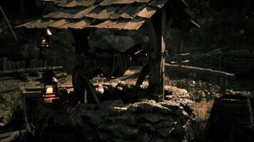 CGI Old stone well in a secluded forest at twilight with lanterns glowing video