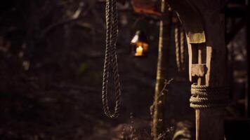 CGI Lantern lights up rustic setting in forest with wooden structure and ropes video