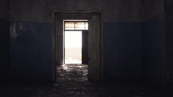 CGI Light streams through an open doorway in an abandoned room at dusk video