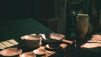 CGI Rustic pottery and decorative plates displayed on wooden table in market video