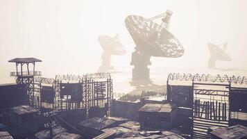 CGI Rustic satellite dishes overlook a foggy abandoned urban area during daylight video