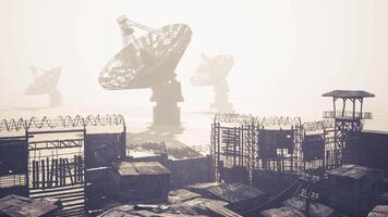 CGI Satellite dishes stand tall against foggy background in abandoned area video