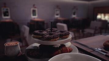 CGI Decadent display of pastries and coffee in a cozy cafe setting video