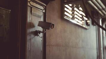 CGI Surveillance camera mounted on a building in an urban area during daylight video