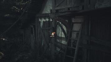 CGI Lantern hanging from rustic wooden structure in a dimly lit forest setting video