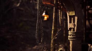 CGI Rustic lantern and ropes hang in a dimly lit wooden structure at dusk video