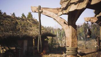 CGI Rustic wooden structure with rope and lantern near traditional dwelling video