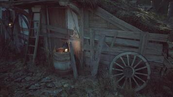 CGI Old wooden cottage with lanterns and barrel near a rocky path at dusk video