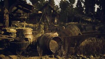 CGI Old wooden barrels and tools abandoned in a rural setting at dusk video