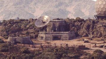 CGI Satellite dish and concrete structure amid rocky landscape at dawn video