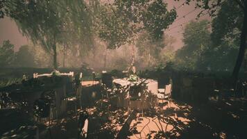 CGI Outdoor dining area with tables surrounded by trees in the evening light video