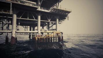 CGI Oil rig structure in ocean with supportive infrastructure at dawn video