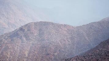CGI Serene mountain landscape with hazy distant peaks under gentle sunlight video