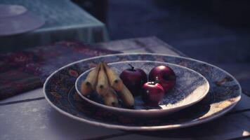 CGI Fruit arrangement on decorative plates with soft lighting in a cozy setting video