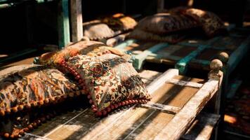 CGI Colorful decorative pillows on rustic wooden benches in a cozy setting video