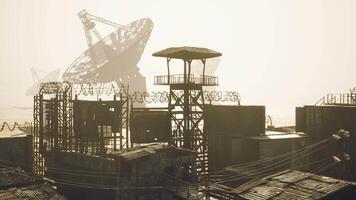 CGI Abandoned industrial site with satellite dishes and rusty structures at dusk video