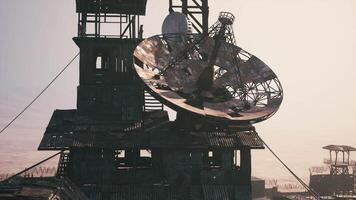 CGI Old satellite dish at a weathered communication tower during sunset video
