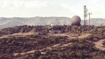 CGI Abandoned surveillance base on a rugged landscape under clear skies video
