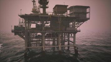 CGI Oil rig operating in the ocean during early morning hours in a misty atmosphere video