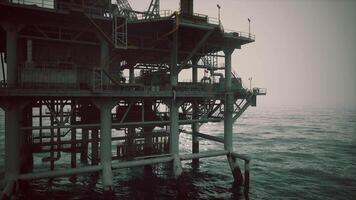 CGI Oil rig stands tall over calm waters during a hazy day video