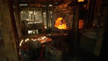 CGI Old forge interior with glowing fire and tools reflecting warm light video