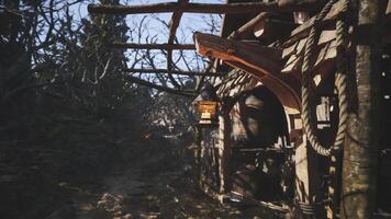 CGI Rustic lantern hangs outside old wooden structure in a serene forest setting video