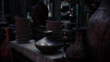 CGI Collection of pottery and plates displayed in a dimly lit artisan shop video