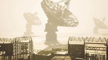CGI Stationary satellite dishes in foggy landscape at a remote location video