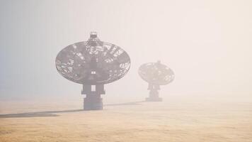 CGI Mystical satellite dishes standing in a foggy landscape at dawn video