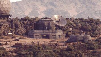 CGI Remote facility surrounded by mountains with satellite dish and structures video