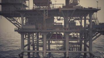 CGI Oil rig structure operating in the ocean during early morning light hours video