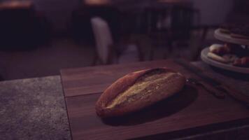 CGI Freshly baked bread on a wooden cutting board in a cozy cafe setting video