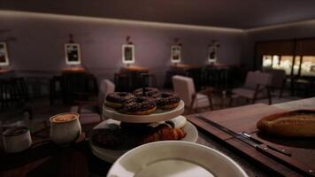 CGI Cozy cafe setting with freshly baked donuts and warm beverages in evening light video