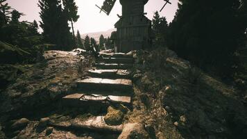 CGI Old windmill on rocky path surrounded by tall trees in bright daylight video