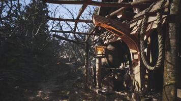 CGI Lantern hanging from wooden structure in a forest clearing during daytime video
