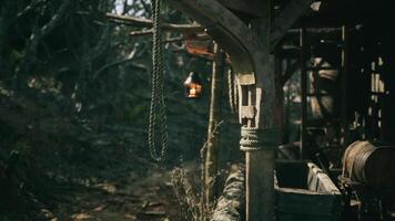 CGI Rustic wooden structure with a lantern in a forest clearing at dusk video
