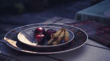 CGI Fruit bowl displayed on a table in outdoor setting during early evening video