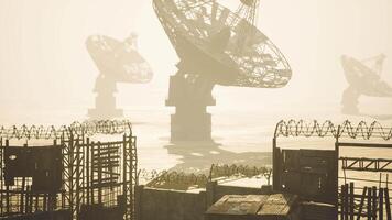 CGI Abandoned satellite dishes in a foggy landscape at dusk video