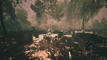 CGI Serene outdoor gathering with tables under trees during golden hour video