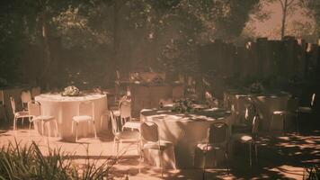 CGI Outdoor dining setup with round tables and floral arrangements in daylight video