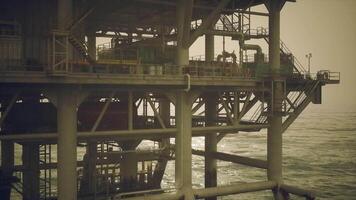 CGI Oil rig operations in a calm ocean environment during sunset hours video