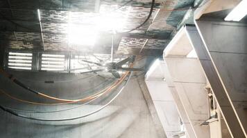 CGI Industrial setting with exposed cables and bright lighting during daytime video