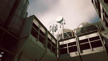 CGI Industrial structure with communication towers under a cloudy sky video